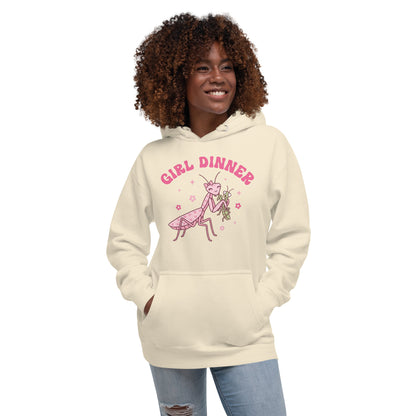 Woman wearing a beige hoodie with 'Girl Dinner' graphic design on a white background