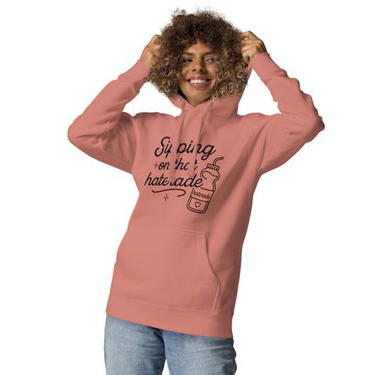 Lifestyle view of woman wearing clay-colored Haterade hoodie
