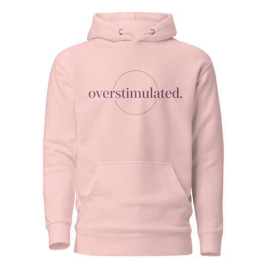Pink hoodie with 'overstimulated' text on a white background