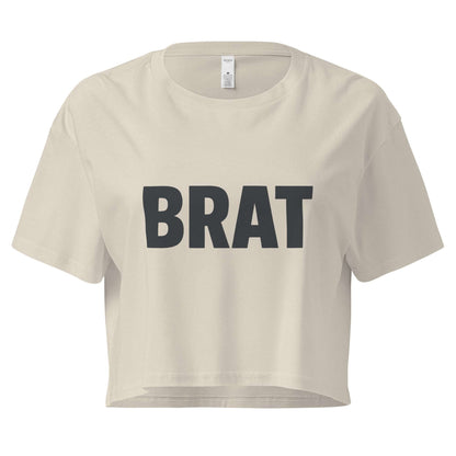 Beige crop top with 'BRAT' text on a white background