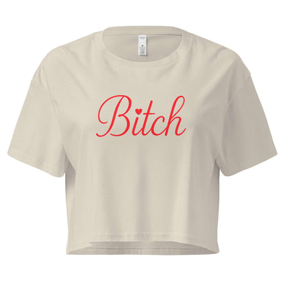 Beige crop top with 'Bitch' printed in red on a white background
