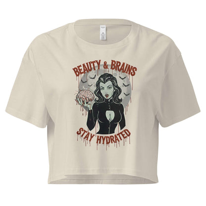 Beige t-shirt with graphic design featuring a woman and text 'Beauty & Brains Stay Hydrated' on a white background