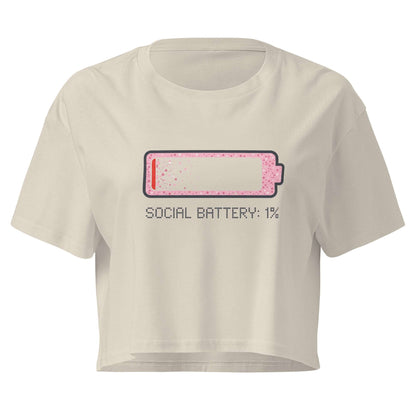 Beige crop top with a graphic of a battery icon and text 'SOCIAL BATTERY: 1%' on a white background
