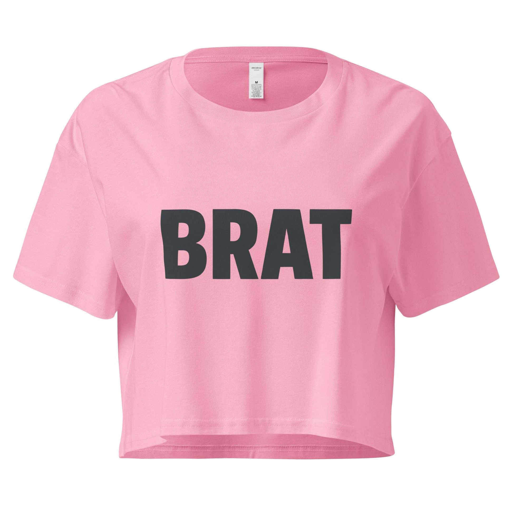 Pink crop top with 'BRAT' text on a white background