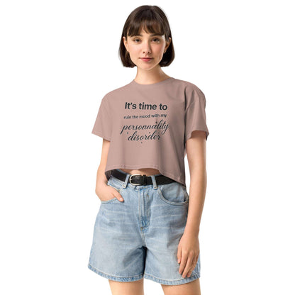 Person wearing a t-shirt with text and denim shorts on a white background