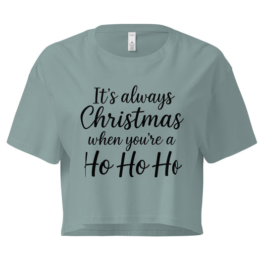 Women’s sage green crop top with black “It’s always Christmas when you’re a Ho Ho Ho” text design in ChibiChibi style.