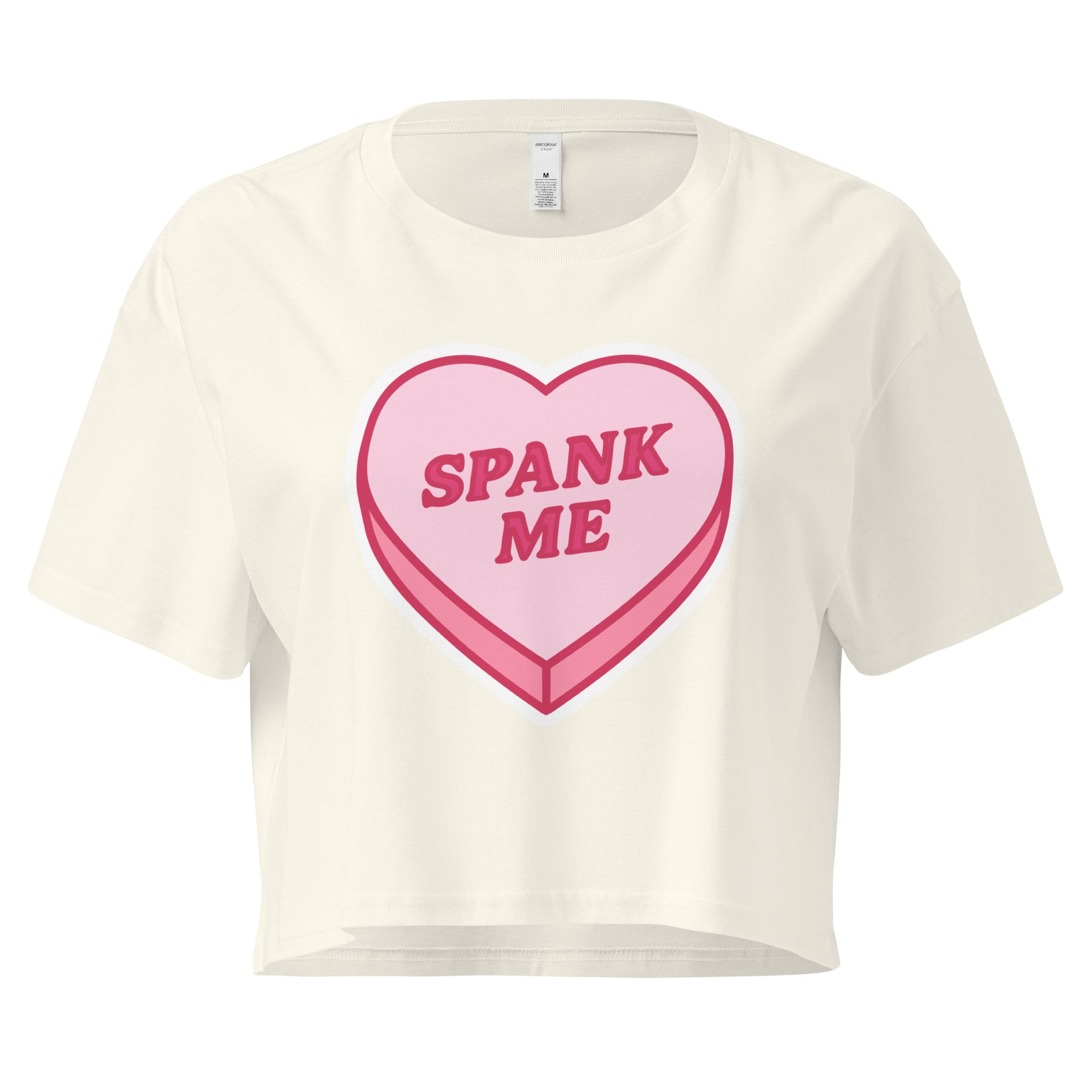 White t-shirt with a pink heart-shaped candy design and 'SPANK ME' text on a white background
