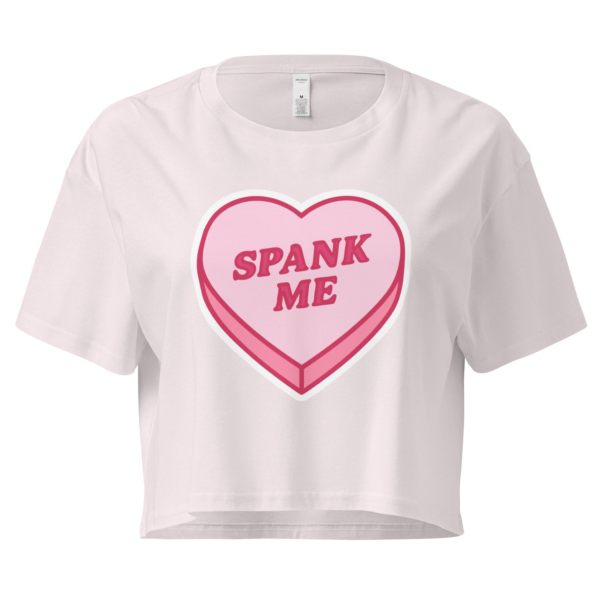 White crop top with a pink heart-shaped candy design and 'SPANK ME' text on a white background.