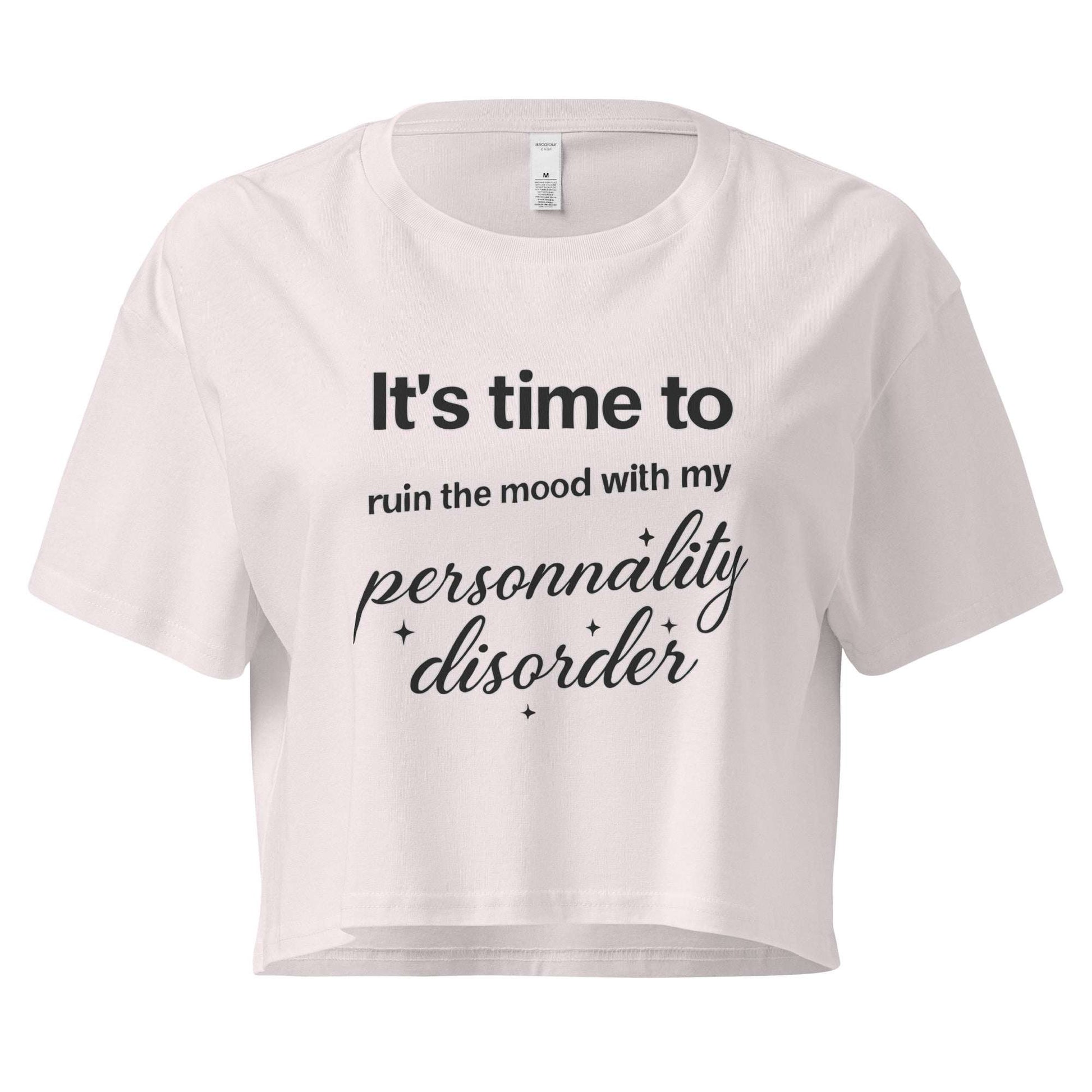 White crop top with black text on a white background