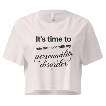 White crop top with black text on a white background