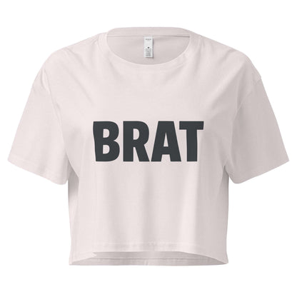 White crop top with 'BRAT' printed in black on a white background