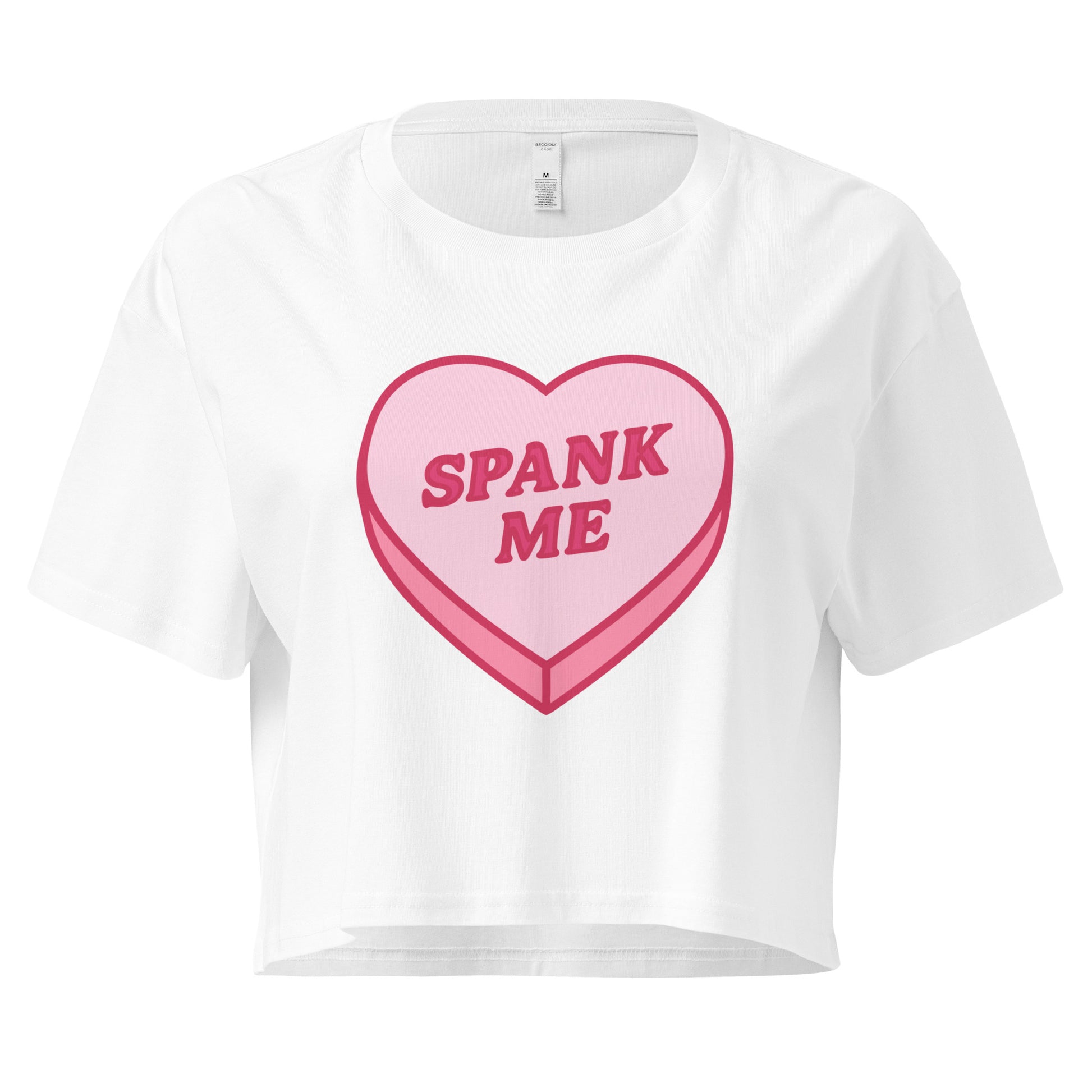 White t-shirt with a pink heart-shaped candy design and 'SPANK ME' text on a white background